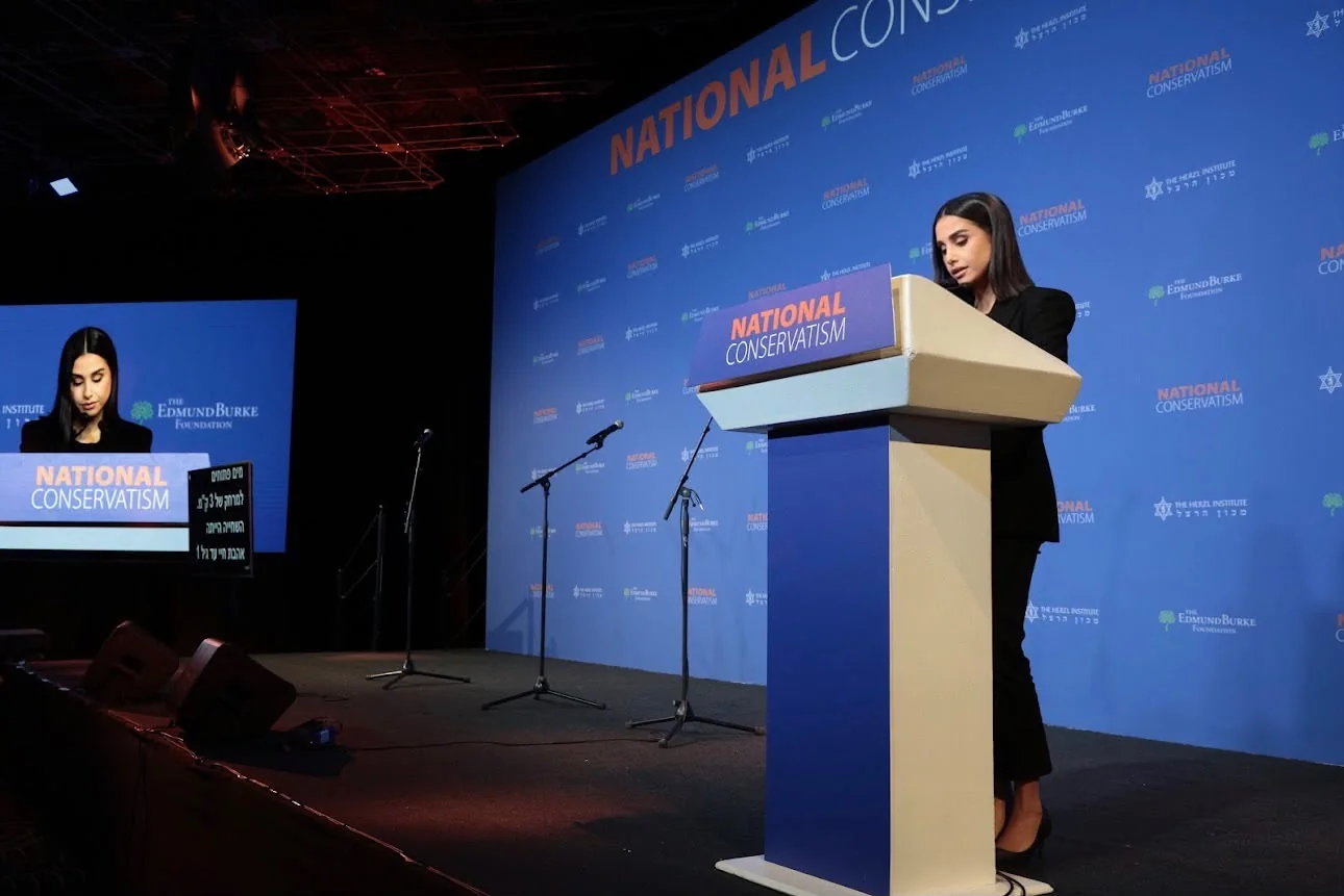 Wide view of Maggie Tabibi and the NatCon stage
