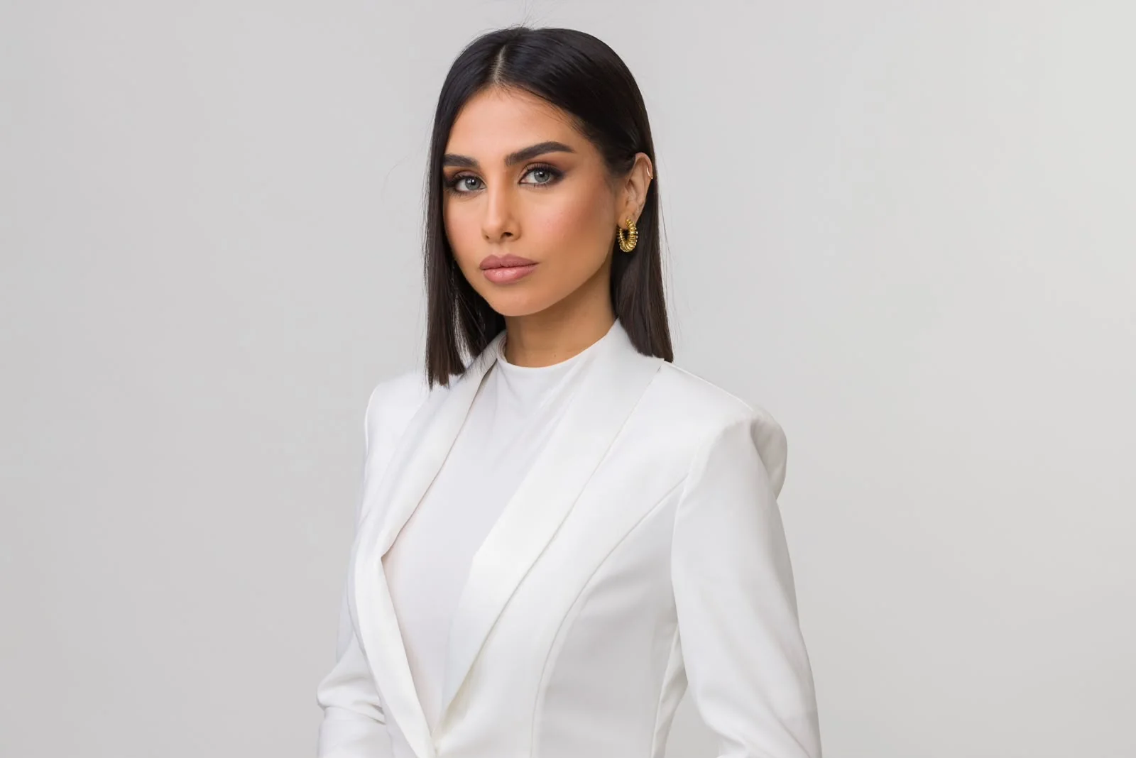 Maggie Tabibi in a white suit